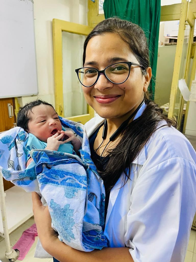 Dr. Preeti Garg with a newborn — a WCare Ayurveda success story
